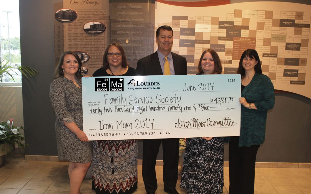 Kim Beanland and Family Service Society receive check from Iron Mom